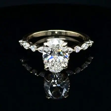 Large oval diamond engagement ring with marquise and round accent diamonds along the band
