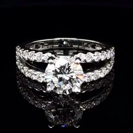 Round diamond engagement ring with a diamond-set split-shank white gold band