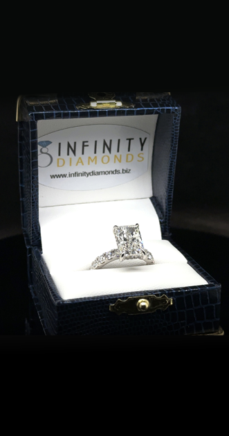 Emerald-cut diamond engagement ring in an Infinity Diamonds ring box
