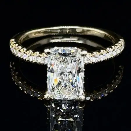 Radiant-cut diamond engagement ring with a pavé yellow gold band