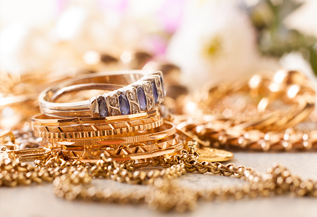 Gold bangles, chains and a ring set with blue gemstones