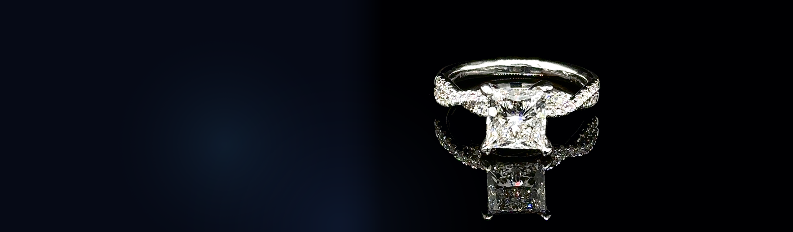 Princess-cut diamond engagement ring with a twisted pavé band in white gold