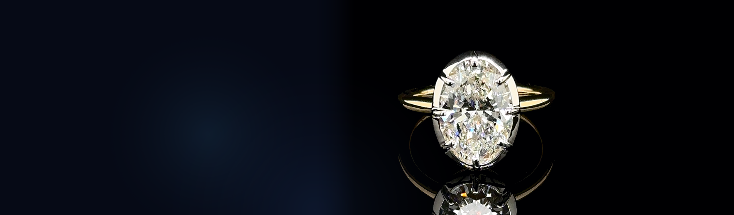 Oval diamond solitaire engagement ring on a yellow gold band