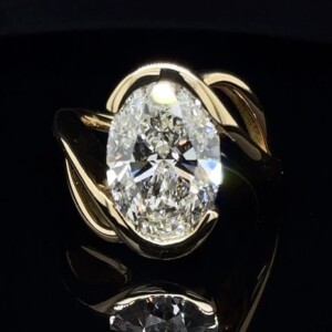 5-carat oval diamond in a yellow gold bypass setting