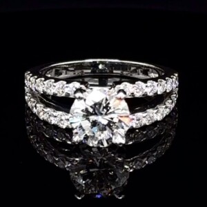 Round diamond engagement ring with a diamond-set split-shank white gold band