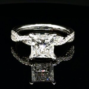 Princess-cut diamond engagement ring with a twisted pavé white gold band