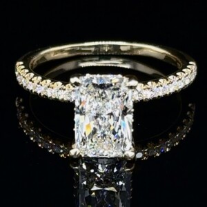 Radiant-cut diamond engagement ring with a pavé yellow gold band